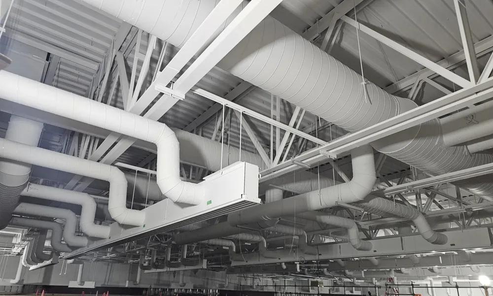 Air distribution ductwork and mechanical services inside a large facility.